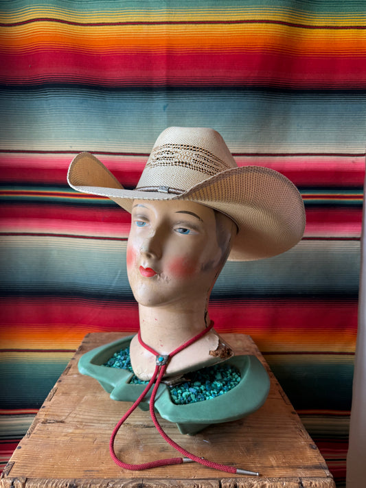 Straw cowboy hat with vented crown and leather embellished hatband. 